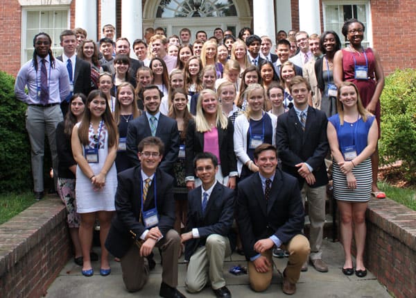 Winners of the Congressional Essay Contest stand in front of a brick building