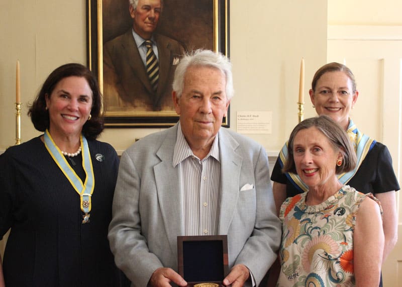 Katherine Cammock, Carol Cadou, and Bethe M. Hagopian pose with a white haired man in a gray suit