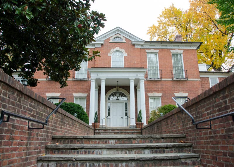 Shot of the front walk of Dumbarton House, shows the brick steps that lead up to the white front door